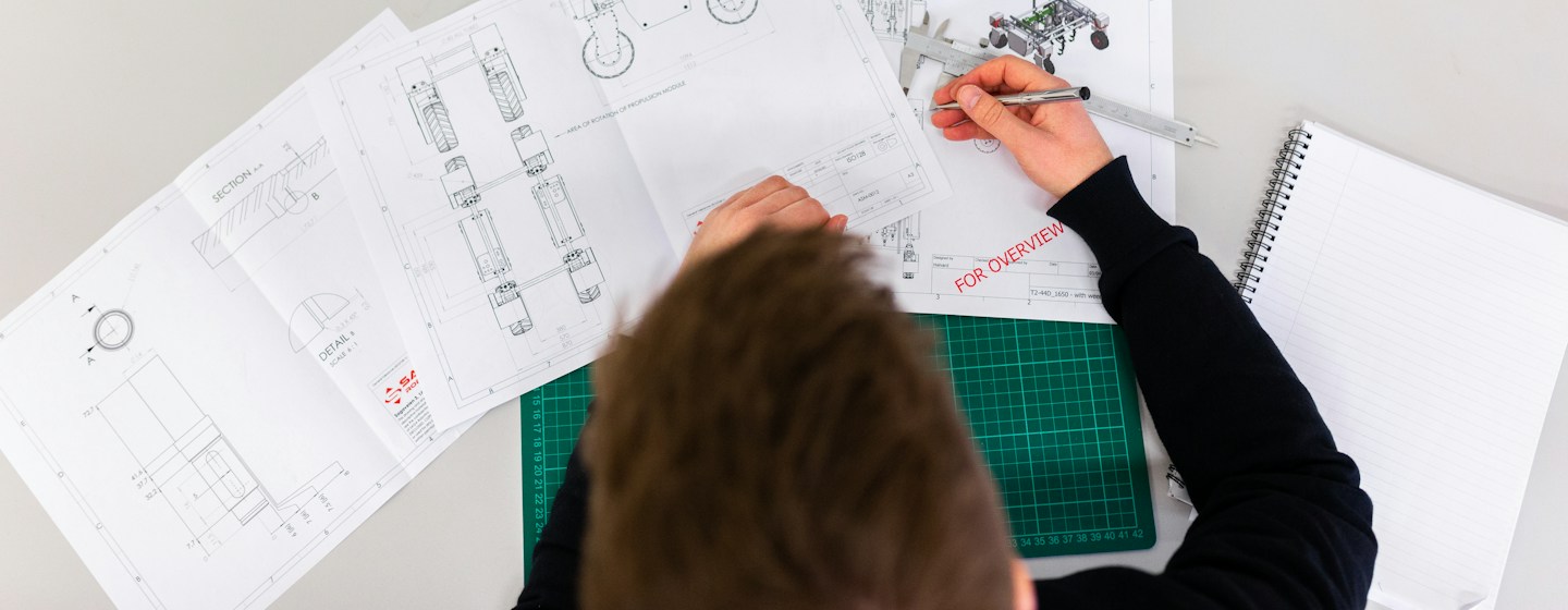 Engineer working on product blueprints